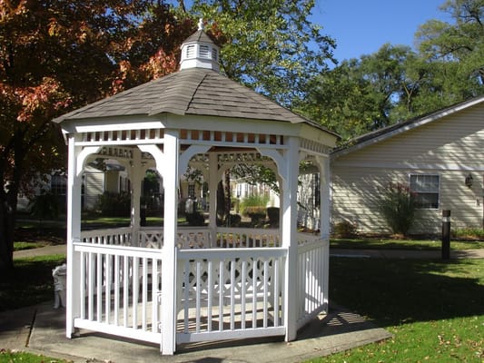A gazebo in a landscaped garden area