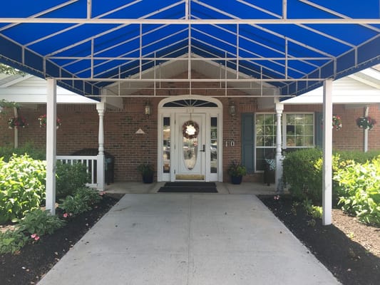 Entrance of a nursing home with a blue awning