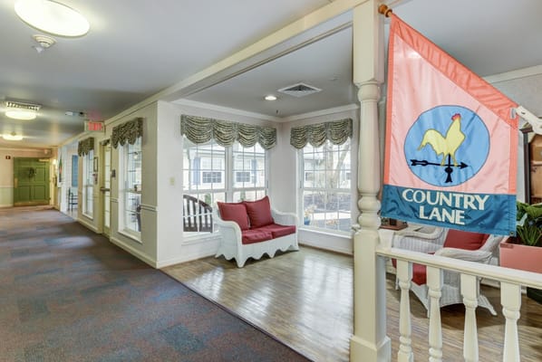 Bright corridor with seating and decorative flag.