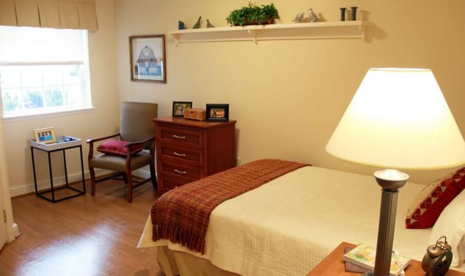 Cozy resident room with a bed and lamp