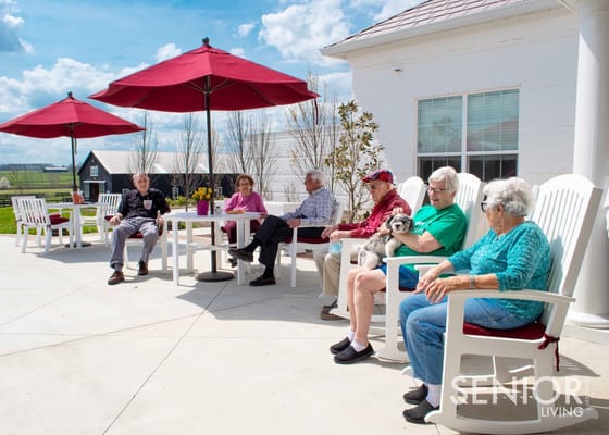 Residents enjoying time outdoors under umbrellas