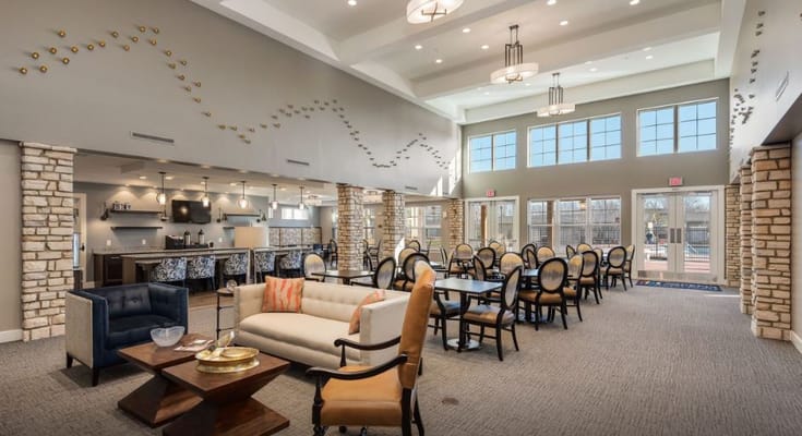 Bright common area with seating and large windows