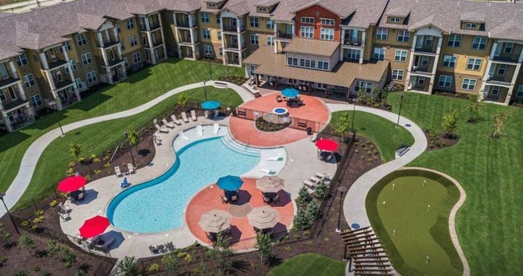 Aerial view of a senior living facility with a pool and outdoor seating