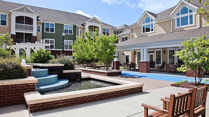 Scenic view of a courtyard with water feature and seating