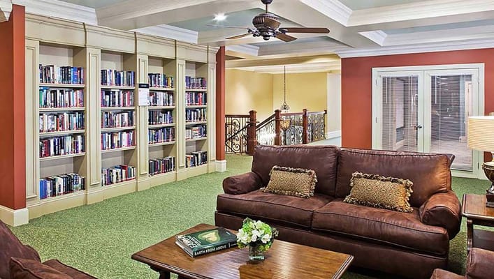 Cozy common area with bookshelves and comfortable seating