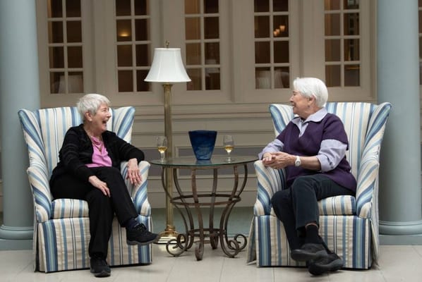 Two residents enjoying conversation in a common area