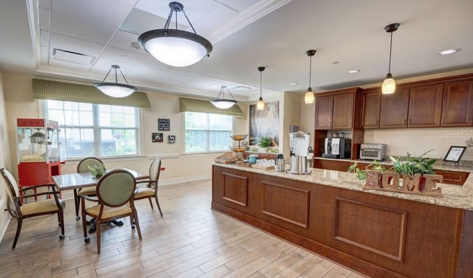 Bright common kitchen area with tables and decor