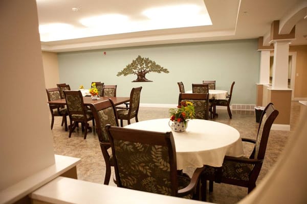 Bright dining area with tables and a mural