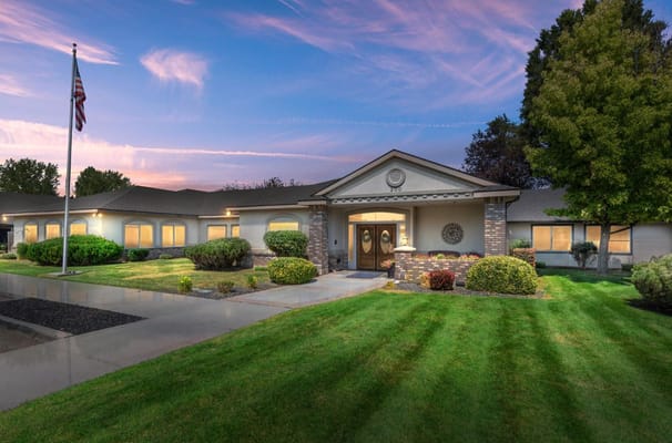 Exterior view of a senior living facility with landscaped grounds