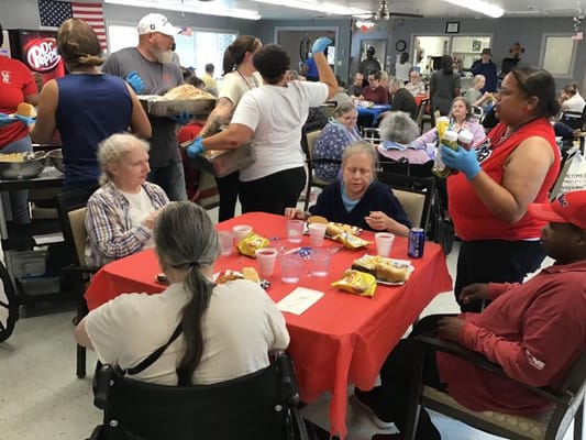 Residents and staff enjoying a meal together in a common area
