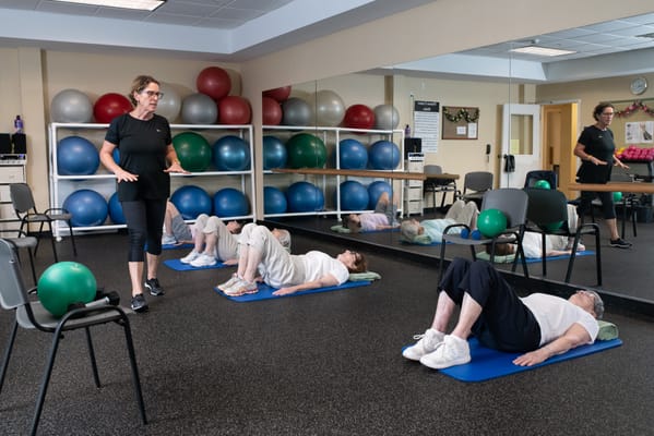 Residents participating in a fitness class in a gym