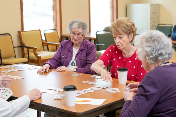Residents playing cards in a social setting