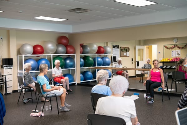 Residents participating in a seated exercise class