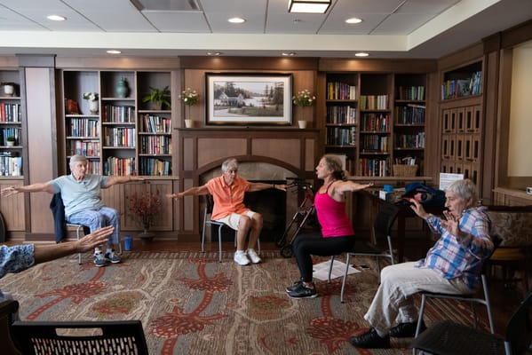 Residents participating in a seated exercise class