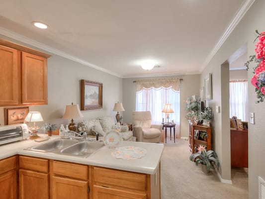 Living room with beige furniture and wooden cabinets