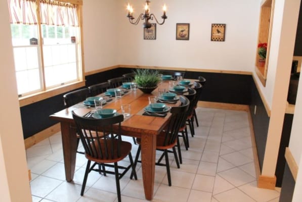 Dining room setup with a long table and chairs
