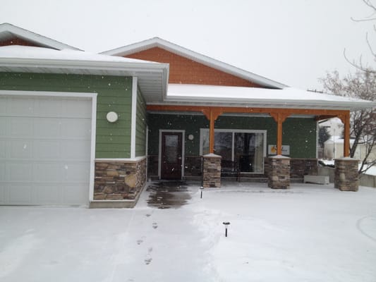 Building entrance of a senior living facility during snowfall