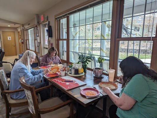 Residents engaging in a craft activity at a communal table
