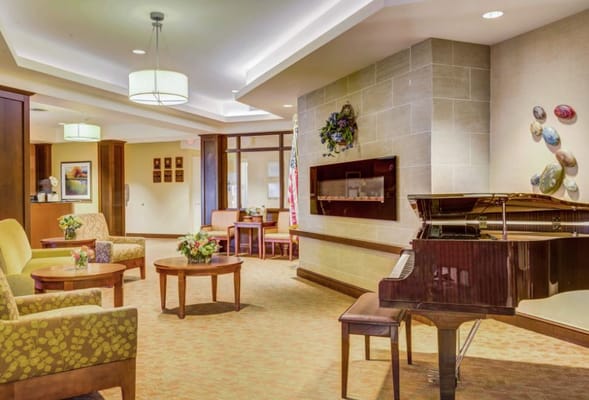 Bright common area with seating and a piano
