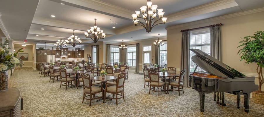 Elegant dining area with grand piano and chandeliers