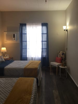 Brightly lit shared bedroom in assisted living facility