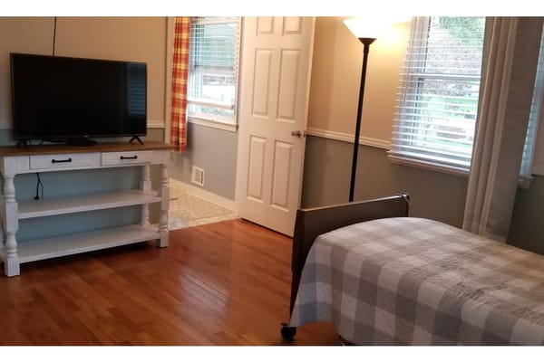 Cozy resident room with a bed and TV