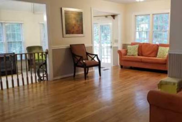 Bright interior common area with a couch and chairs