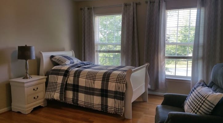 Cozy interior of a private resident room with a bed