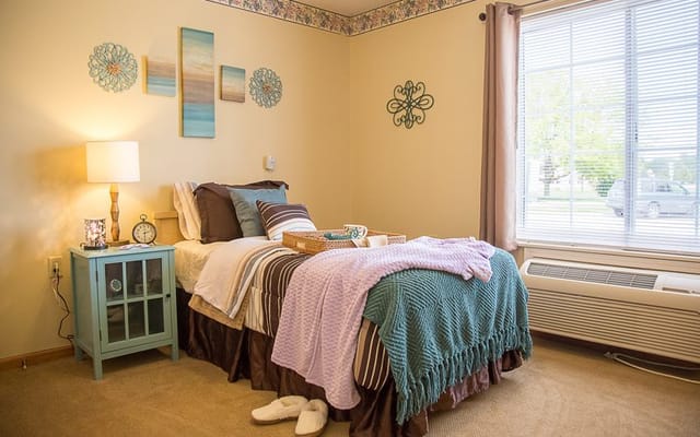 Cozy resident room with bed, décor, and natural light