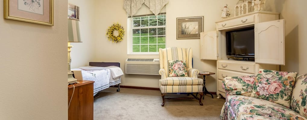 Cozy private resident room with floral decor and comfortable seating