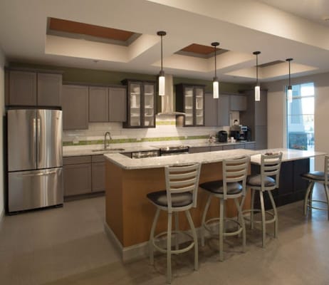 Modern kitchen area with bar seating and appliances