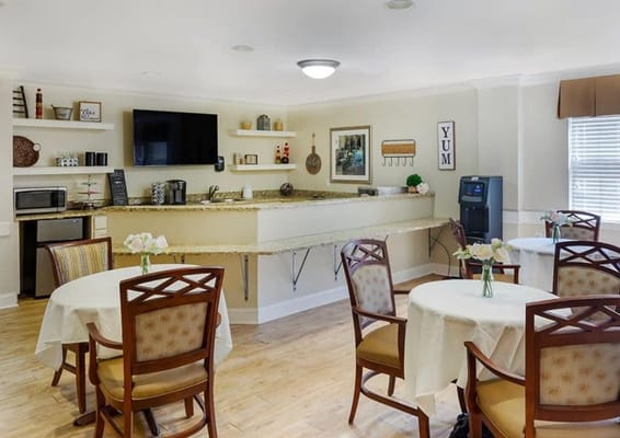 Bright dining room with tables and flowers