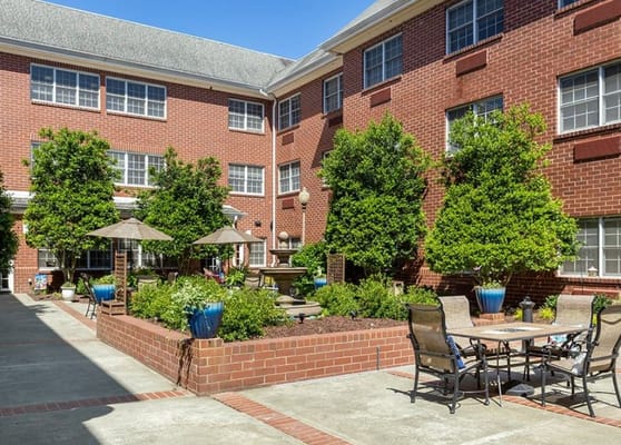 Well-maintained outdoor courtyard with seating and plants