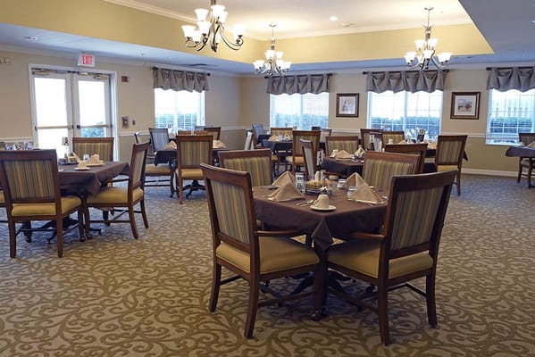 Dining room setup with tables and chairs