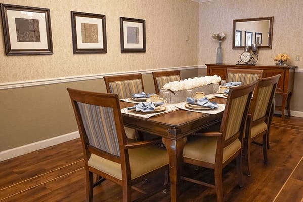 Dining room with a large wooden table set for a meal