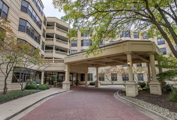 Front entrance of a senior living facility with landscaping