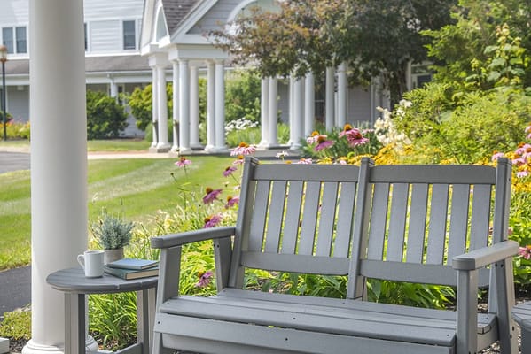 A serene outdoor seating area surrounded by flowers