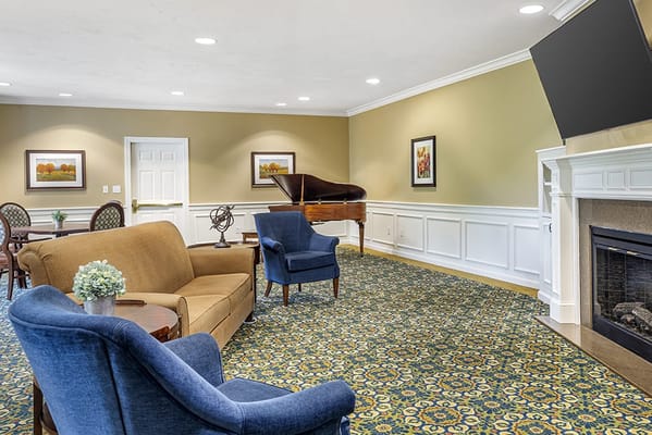 Bright common area with comfortable seating and a piano