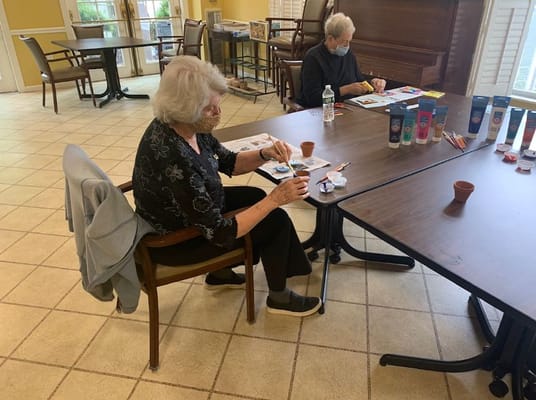 Residents engaging in an arts and crafts activity indoors