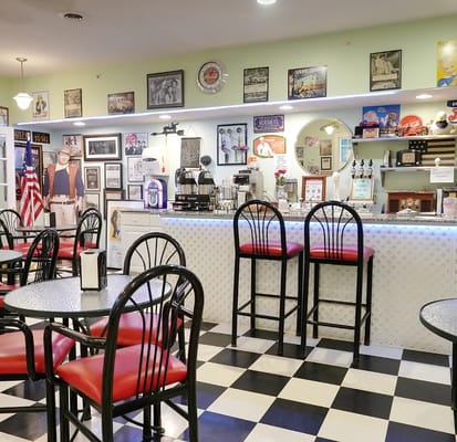 Interior view of a cafe area with seating and decorations