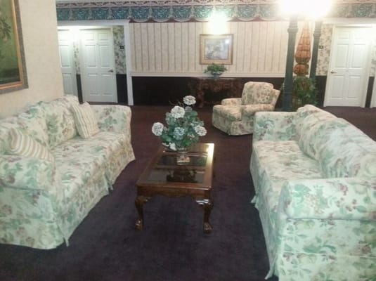 Cozy interior common area with floral sofas and a coffee table