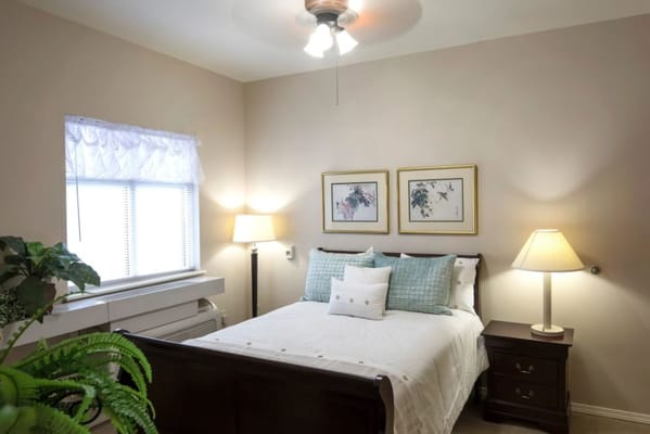 Cozy private resident room with bed and lamps