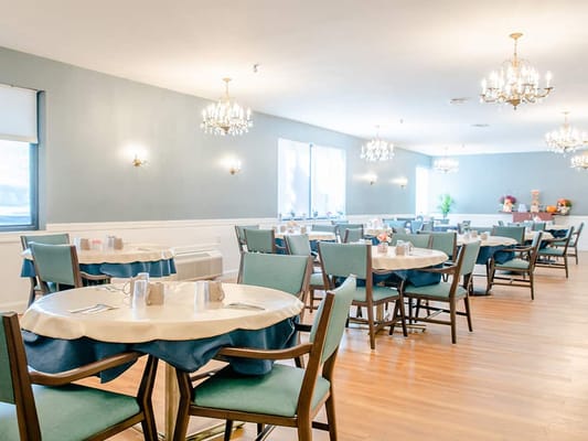 Dining room with tables set for residents