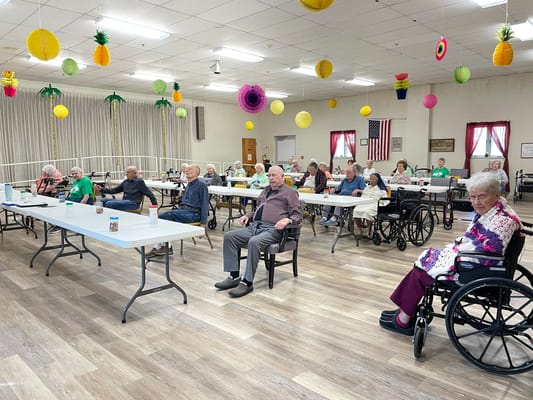 Residents attending an activity session in a decorated common area