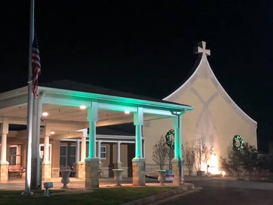 Exterior view of Carmel Home at night with decorations