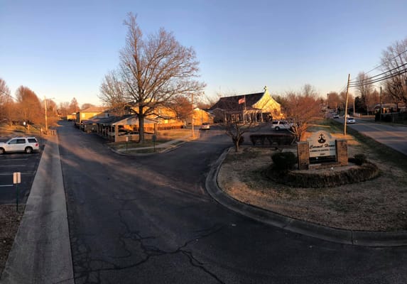Exterior view of Carmel Home facility during sunset