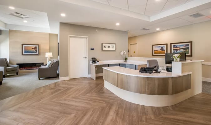 Modern reception area with seating and decorative artwork.