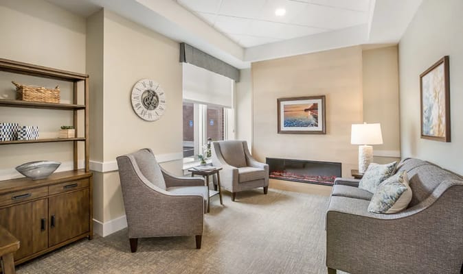 Comfortable living room with seating, fireplace, and artwork