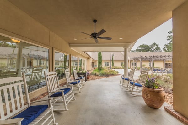 Rocking chairs on the porch of Cedar Crest Memory Care