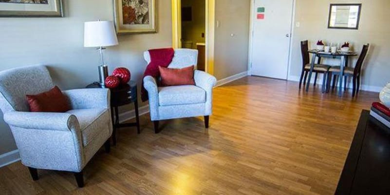 Cozy living area in a resident room with chairs and dining table